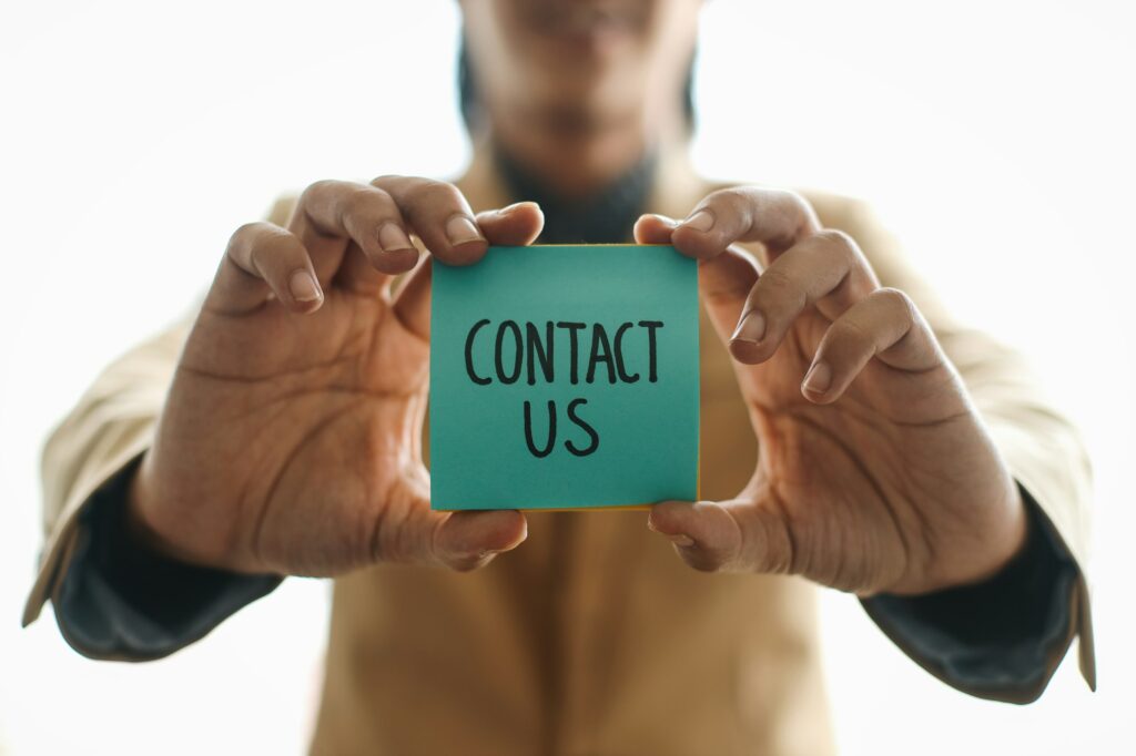 Businessman Showing The Words Contact Us